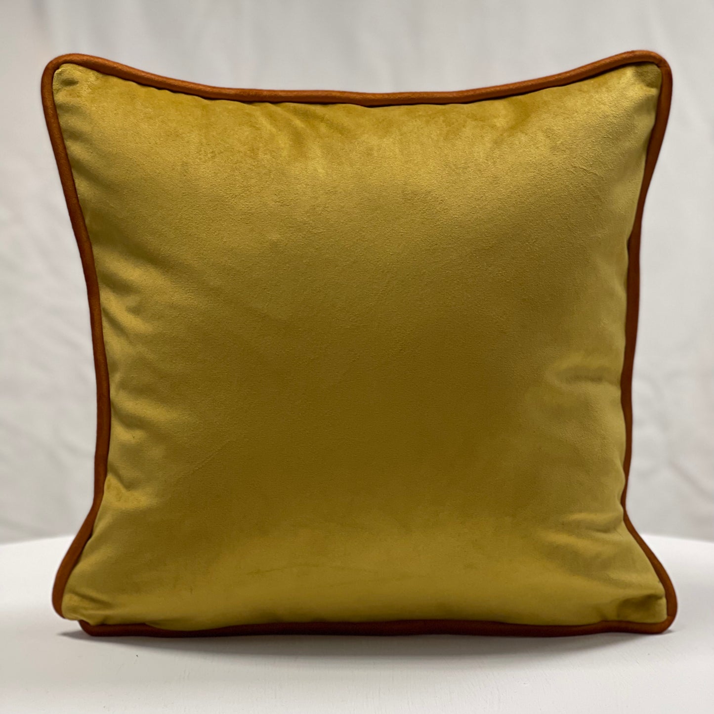 Mustard velvet piped cushion