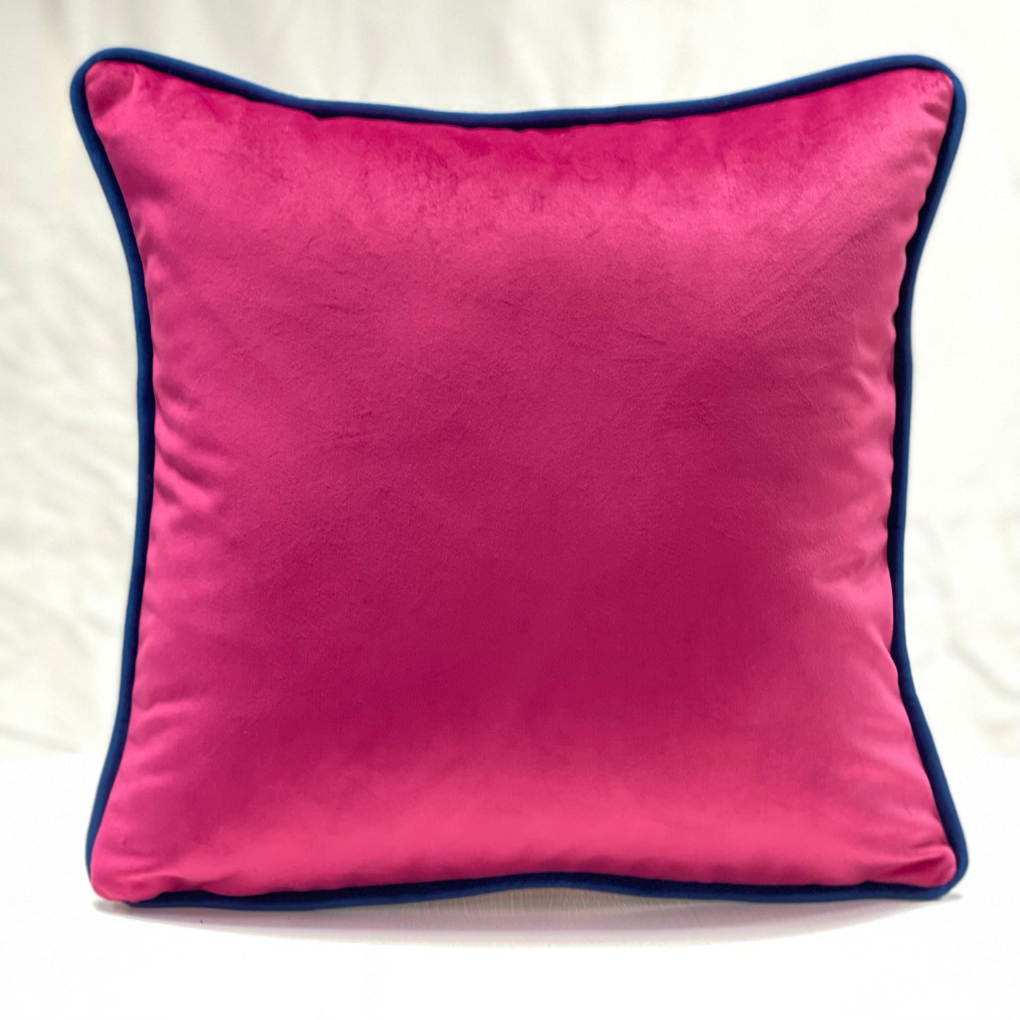 Fuchsia pink velvet piped cushion