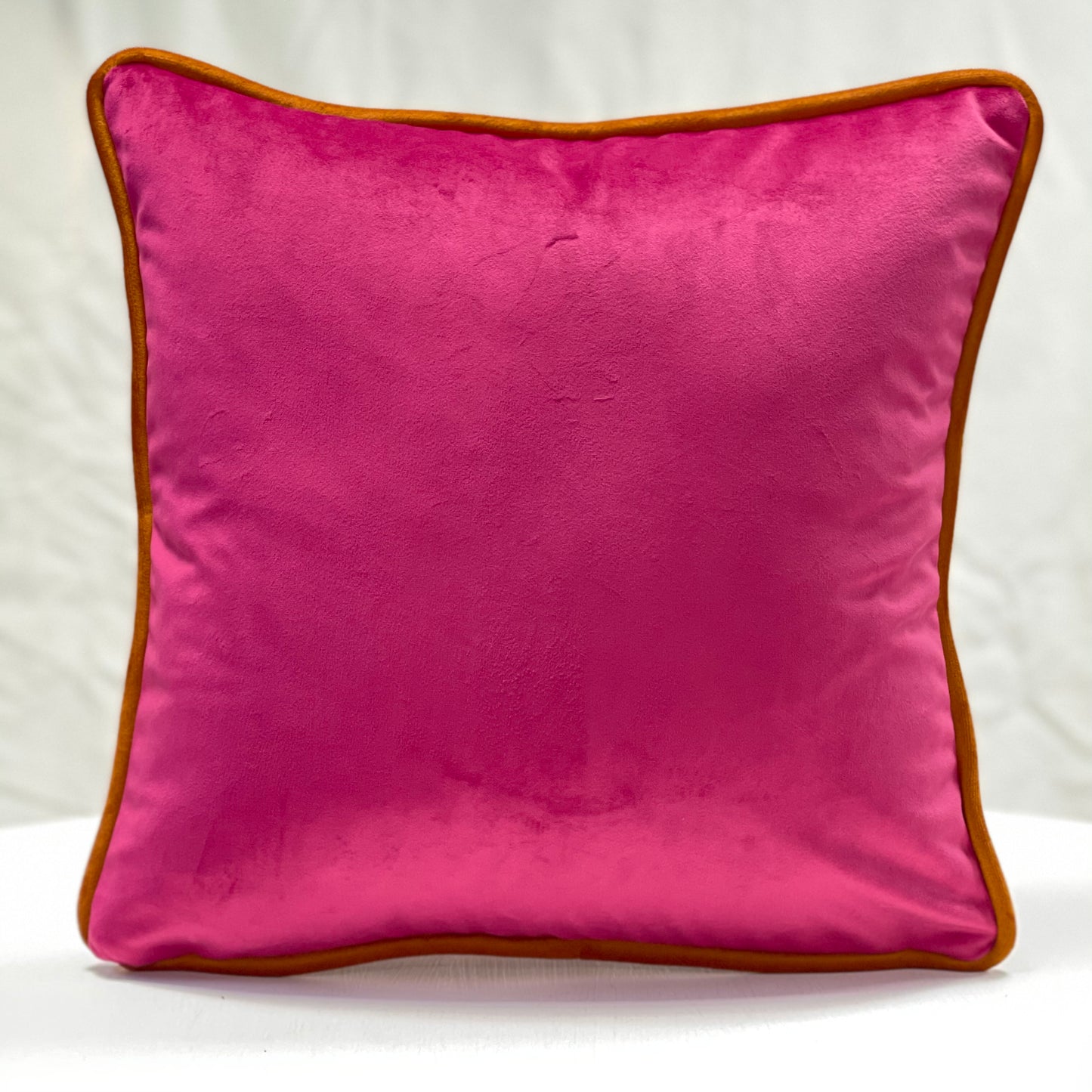 Fuchsia pink velvet piped cushion