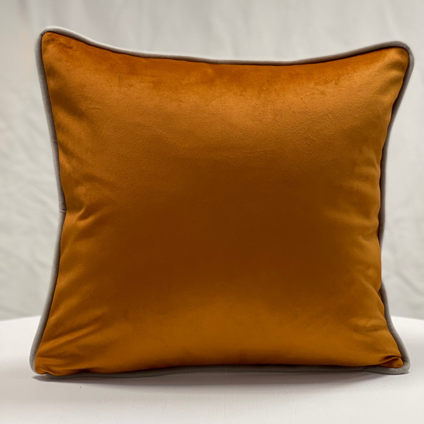 Orange velvet piped cushion