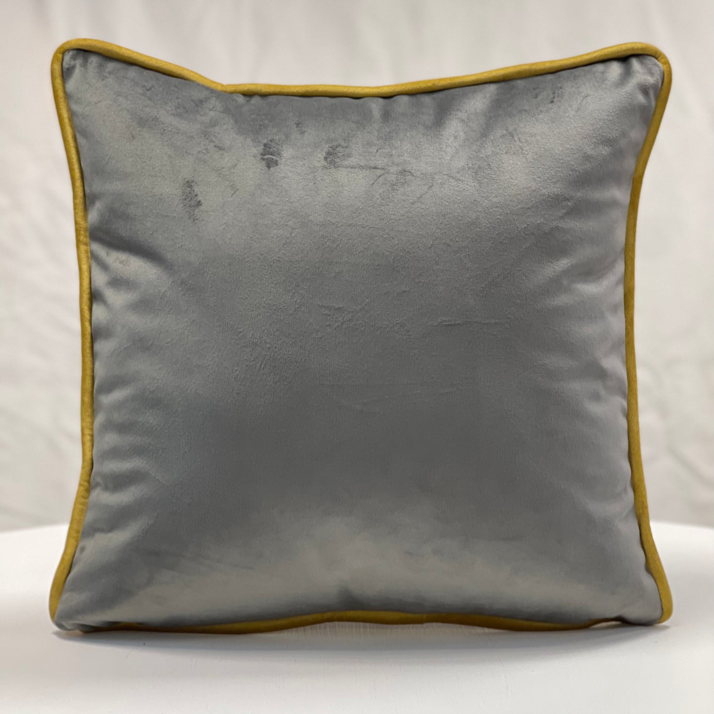 Grey velvet piped cushion