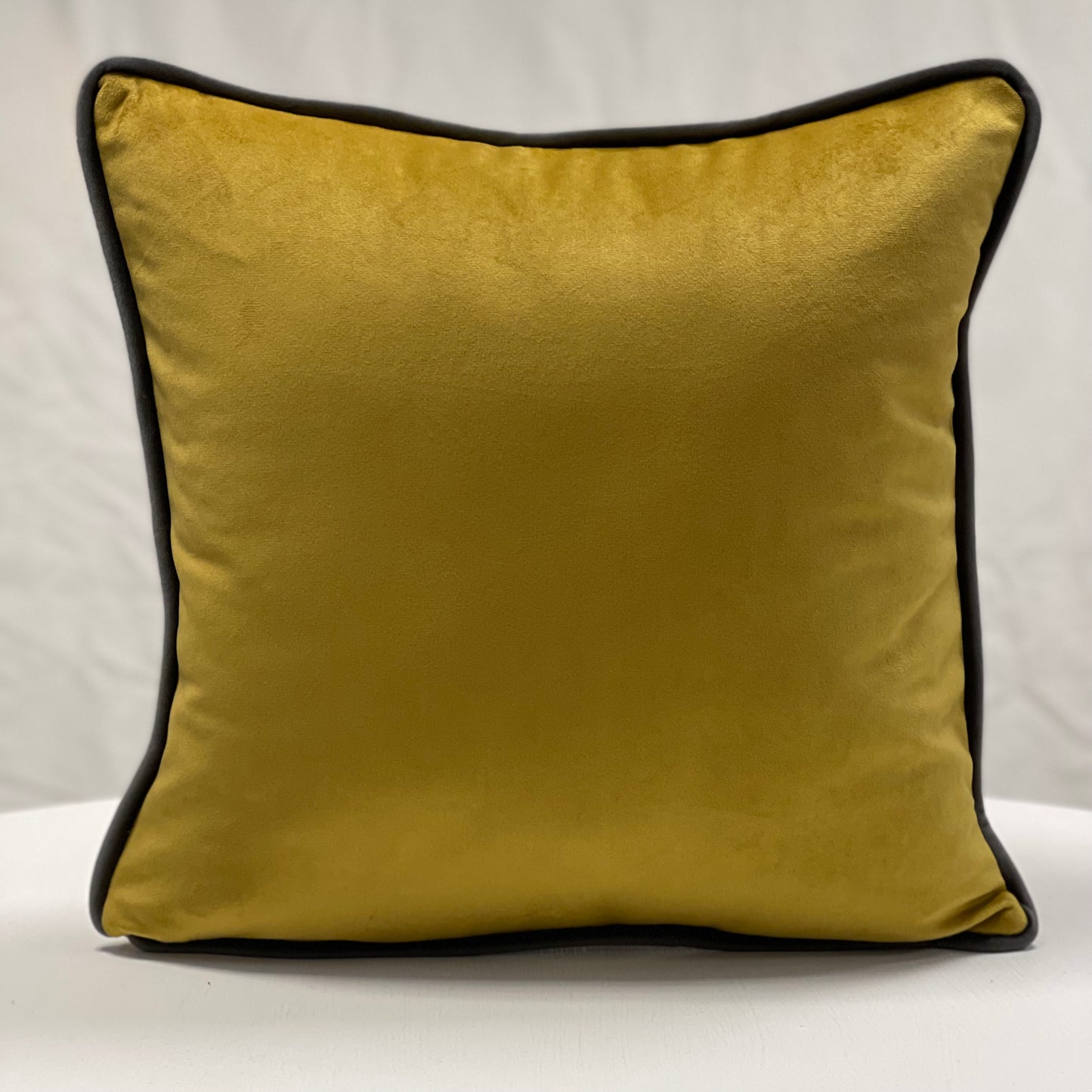 Mustard velvet piped cushion