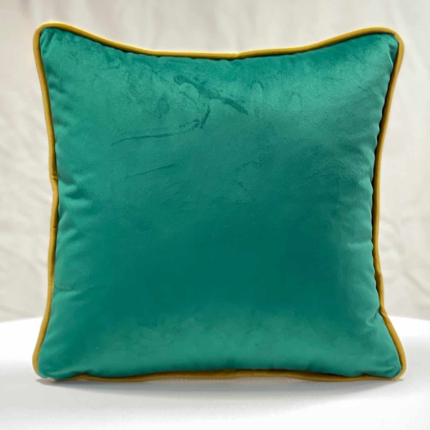 Emerald green velvet piped cushion